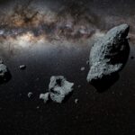 a swarm of asteroids in front of the Milky Way galaxy